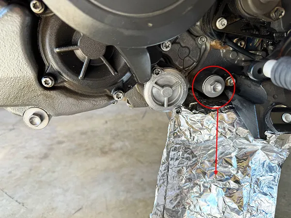 KTM 1290 Adventure Drain Plug with tinfoil over pipe